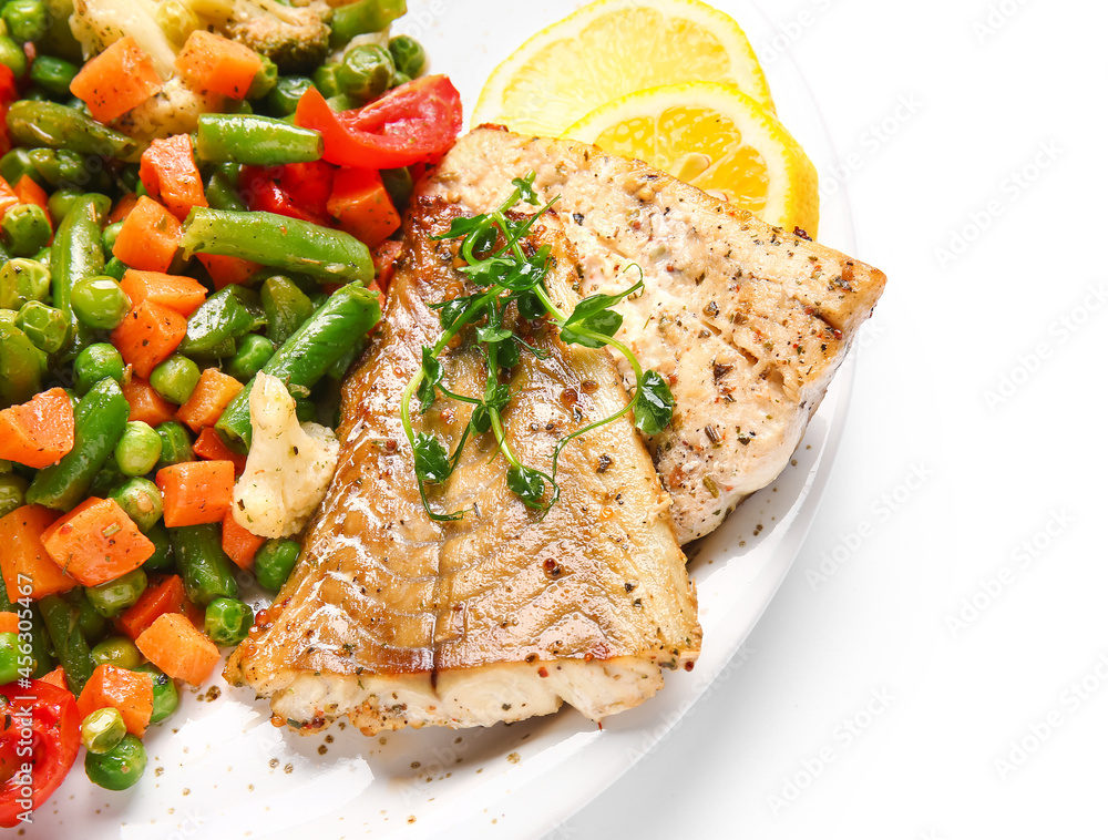 Plate with tasty baked cod fillet and vegetables on white background, closeup