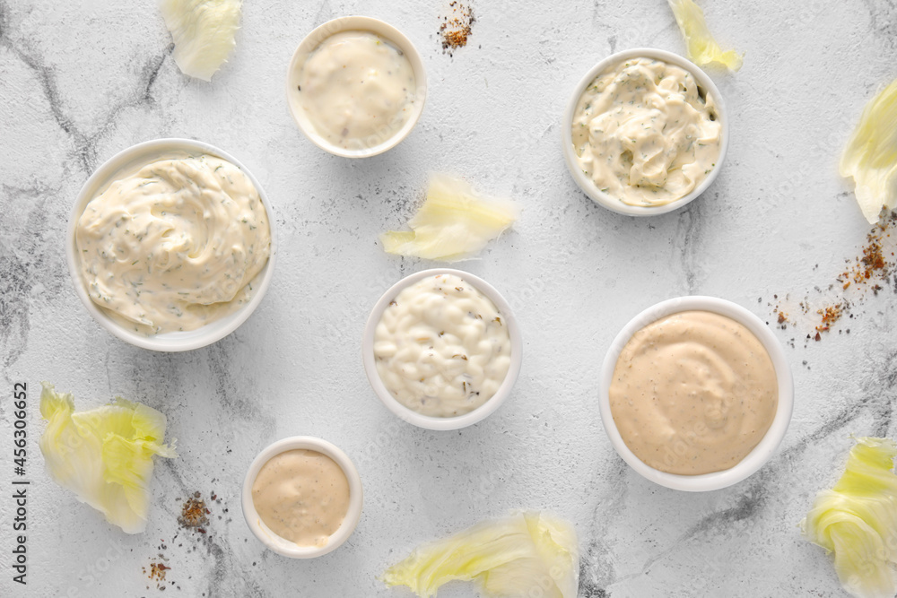 Composition with tasty Caesar sauce on white marble background Composition with tasty Caesar sauce on white marble background