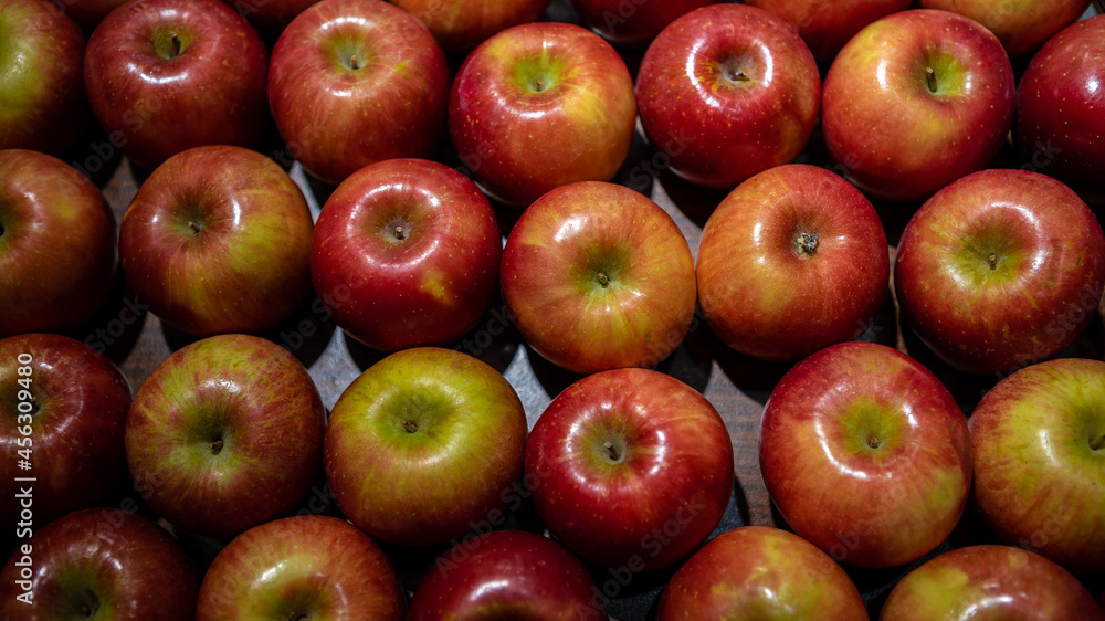 Fresh red apples on market counter. Apples on cardboard box on the grocery shelf Fresh red apples on market counter. Apples on cardboard box on the grocery shelf