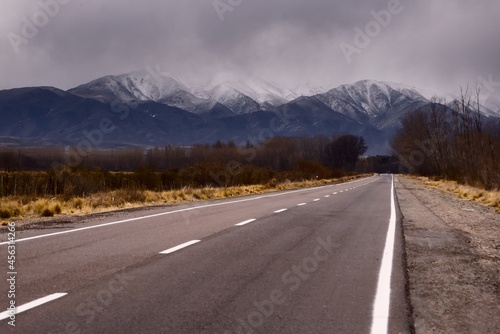 Asphalt road into the snowy Andes mountains in Tupungato, Mendoza, Argentina.