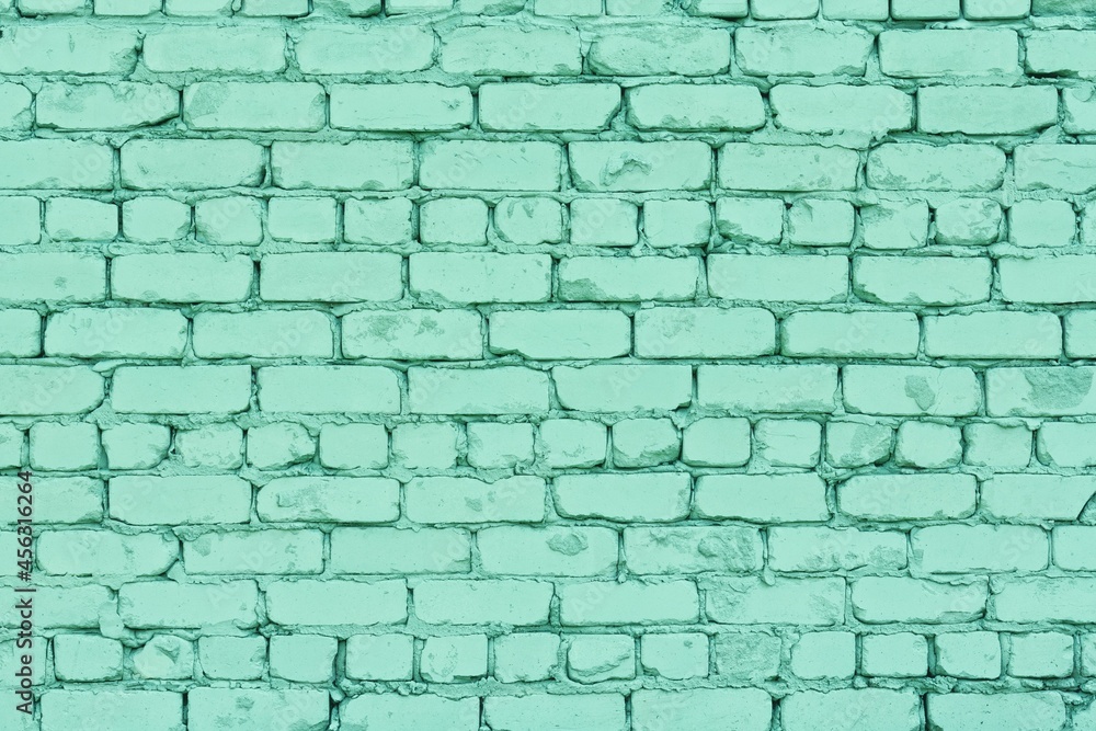Obraz premium Mint green painted old rough brick wall. Pastel teal color texture. Shabby block pattern. Abstract background