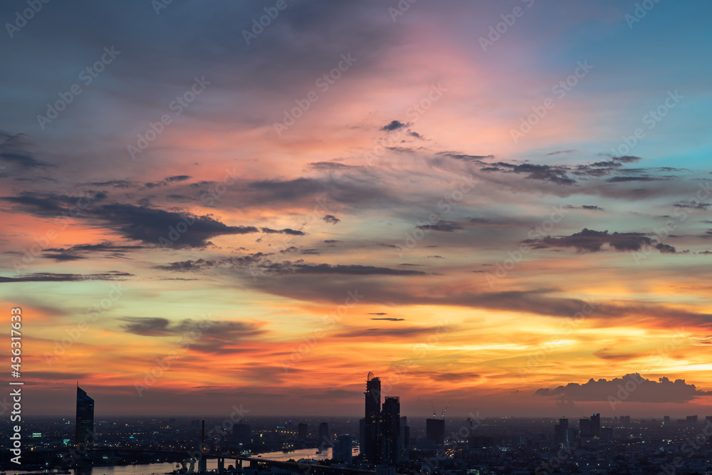 Beautiful sunset sky with dramatic light over large metropol city in Asia. Beautiful blazing sunset landscape, Copy space, No focus, specifically.