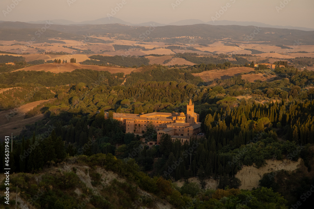 The Abbey of Monte Oliveto Maggiore is a large Benedictine monastery in the Italian region of Tuscany with Karst landscape near Small village Chiusure photographed with a drone.