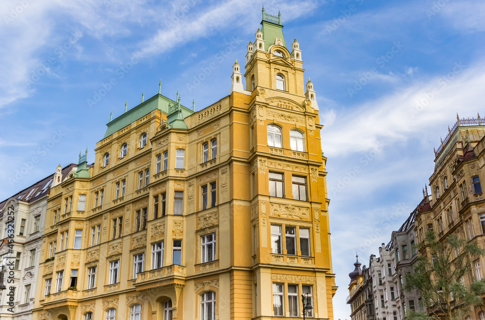 Fototapeta premium Historic yellow apartment building in Prague, Czech Republic