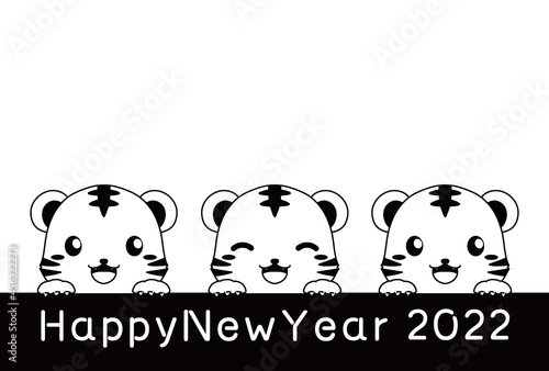 モノクロの ひょっこり顔を出すトラとHappy New Yearの文字と余白のある2022年の年賀状