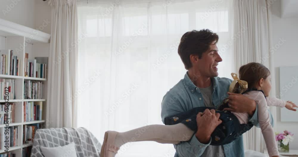 happy father holding little girl pretending to fly playing fun game with dad at home 4k happy father holding little girl pretending to fly playing fun game with dad at home 4k