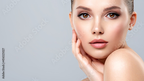 Closeup portrait of a face of the young pretty girl with a healthy skin. Beautiful face of young white woman with a clean skin. Skin care concept.