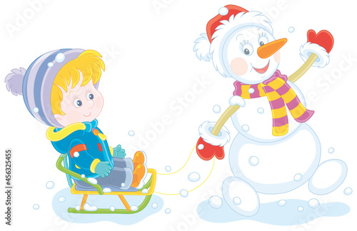 Funny snowman friendly smiling, waving its hand in greeting and sledding a happy little boy on a snowy winter day, vector cartoon illustration isolated on a white background