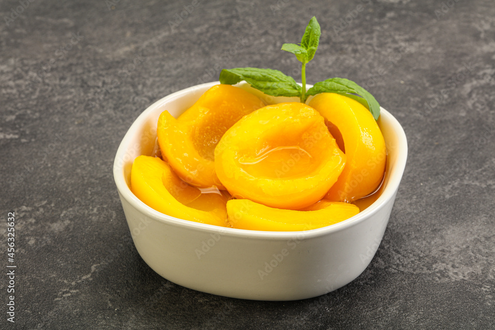 Sweet ripe canned peaches with mint