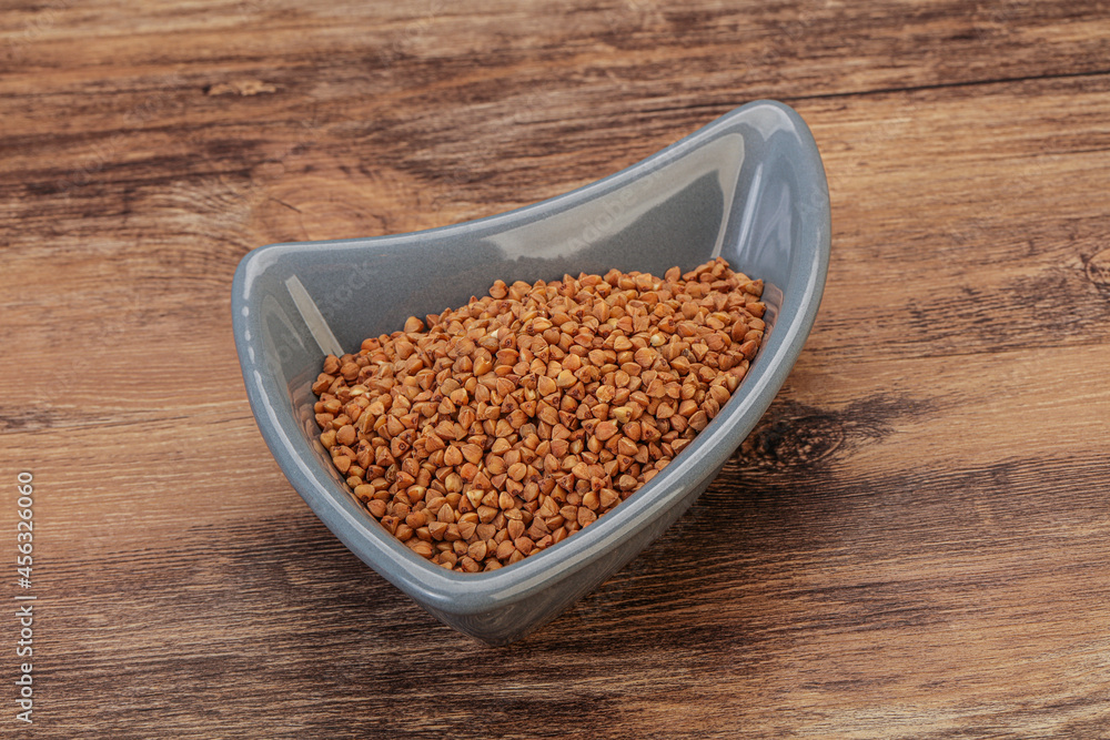 Raw buсkwheat cereal in the bowl Raw buсkwheat cereal in the bowl