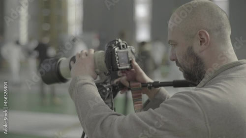 Photographer - cameraman works at a fencing competition photo