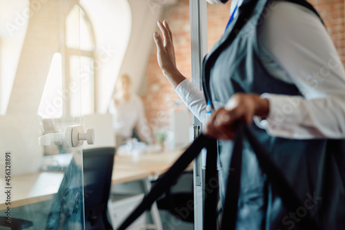 Close-up of food delivery person at entrance door of an business office.