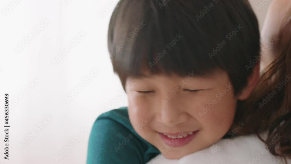 happy little asian boy hugging mother smiling embracing son enjoying motherly love cute child giving hug to mom showing affection at home family concept 4k footage happy little asian boy hugging mother smiling embracing son enjoying motherly love cute child giving hug to mom showing affection at home family concept 4k footage