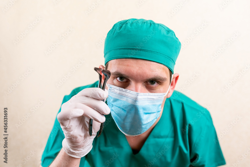 Doctor ENT, wearing a mask and glasses, with a device in his hands. Doctor ENT, wearing a mask and glasses, with a device in his hands.