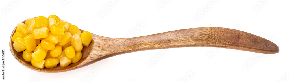 Wooden spoon with raw corn seeds isolated on white background. Raw fresh corn close up. Wooden spoon with raw corn seeds isolated on white background. Raw fresh corn close up.