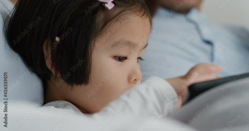 cute little asian girl using tablet computer with family enjoying playing games on touchscreen device relaxing at home together 4k cute little asian girl using tablet computer with family enjoying playing games on touchscreen device relaxing at home together 4k