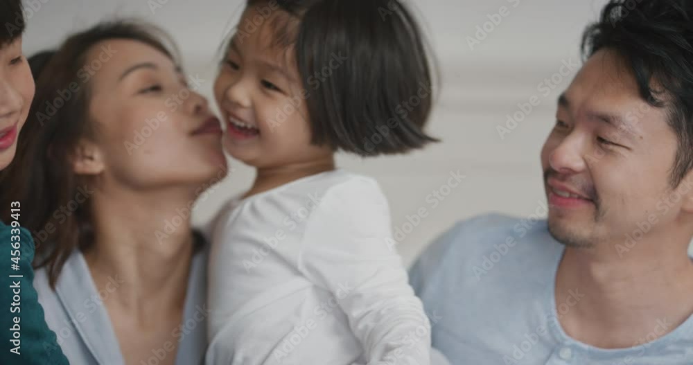 happy asian children jumping on bed little girl and her brother waking up mother and father enjoying playful morning with kids on weekend at home 4k footage happy asian children jumping on bed little girl and her brother waking up mother and father enjoying playful morning with kids on weekend at home 4k footage