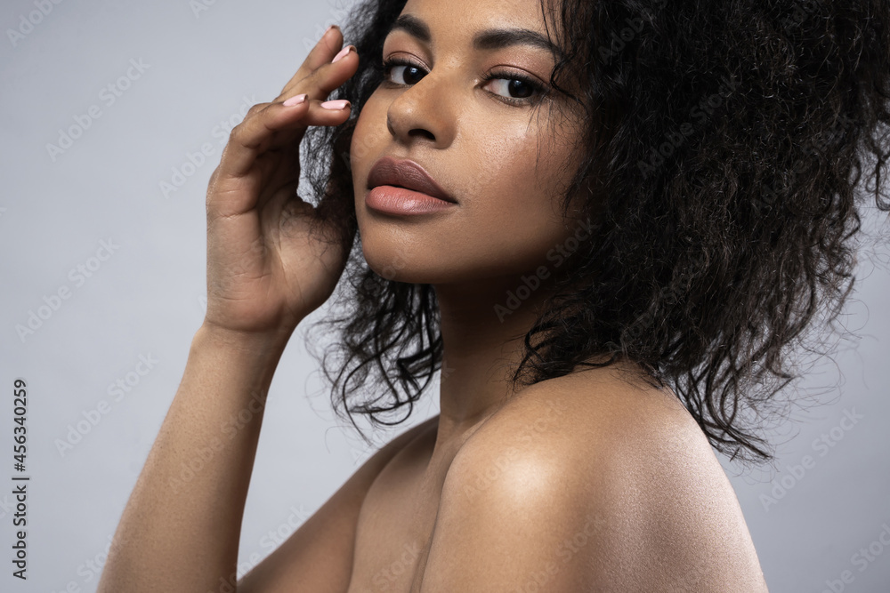 Fototapeta premium Beautiful black woman with smooth skin against gray background