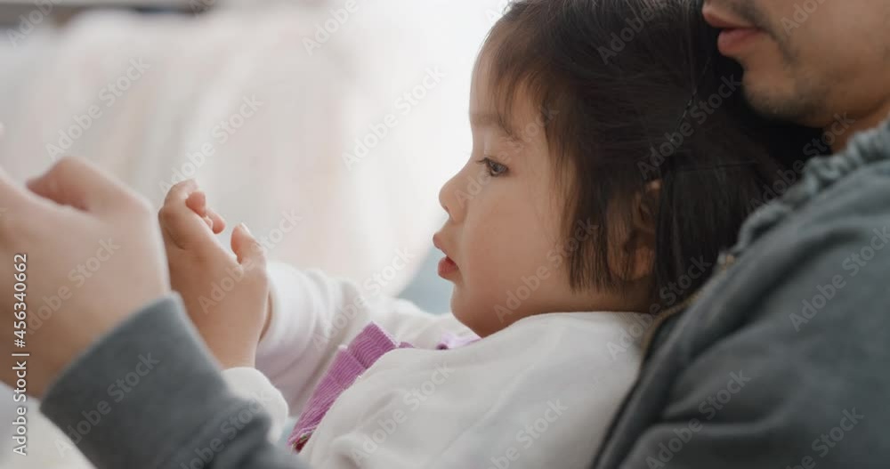 beautiful little asian girl with father having family time dad using smartphone relaxing with daughter at home 4k beautiful little asian girl with father having family time dad using smartphone relaxing with daughter at home 4k