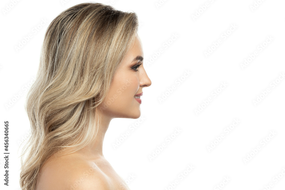 Beautiful blond woman with long wavy hair and smooth skin against white background Beautiful blond woman with long wavy hair and smooth skin against white background