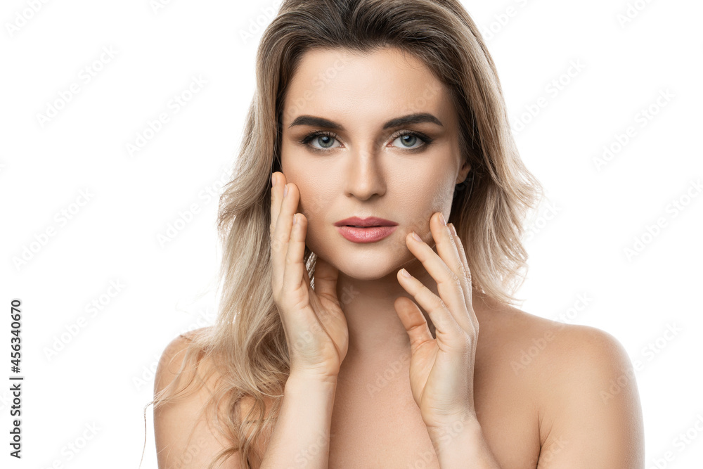 Beautiful blond woman with long wavy hair and smooth skin against white background Beautiful blond woman with long wavy hair and smooth skin against white background