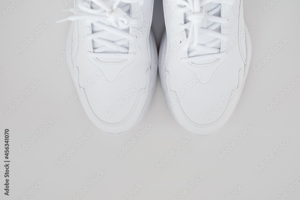 white sneakers with laces on a white background. isolate. top view. white sneakers with laces on a white background. isolate. top view.