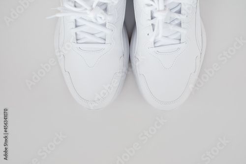 white sneakers with laces on a white background. isolate. top view.