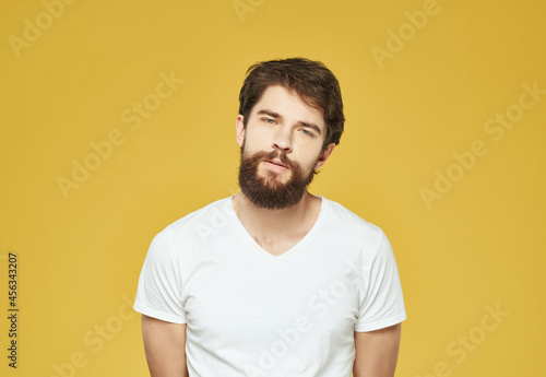 bearded man in a white t-shirt irritated facial expression Lifestyle