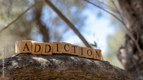 The word ADDICTION was created from wooden cubes. © Caner