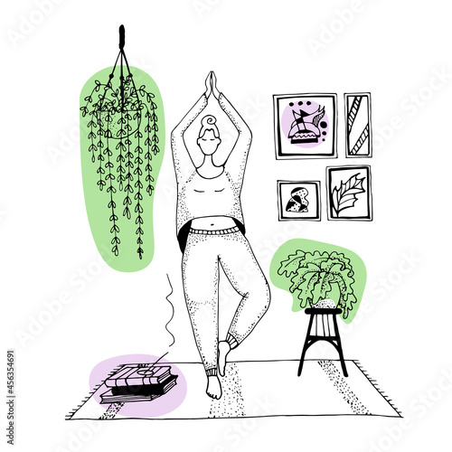a girl in a yoga pose. Asana tree. Fitness at home.