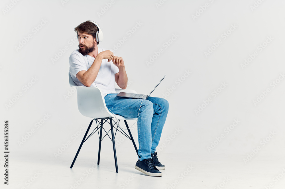 man in white t-shirt with laptop in headphones Lifestyle man in white t-shirt with laptop in headphones Lifestyle
