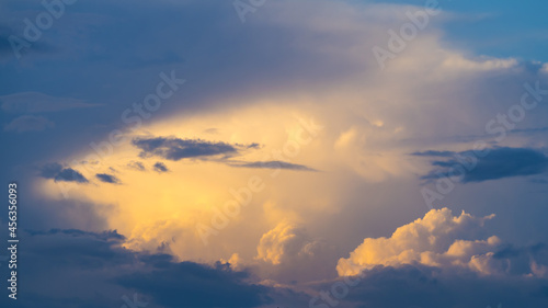 Bizarre sky sight at sunset, sunlit clouds among darkness © Gabdulvachit