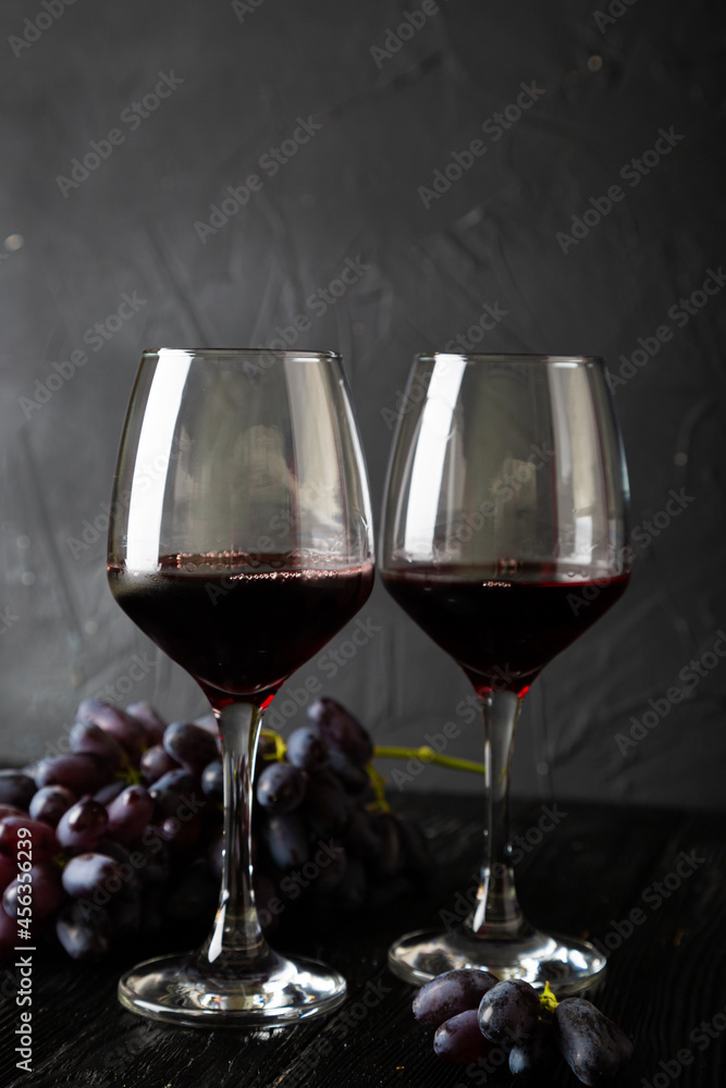 Red wine in a glass and grapes Red wine in a glass and grapes