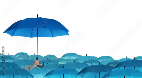 Person holding umbrella over other on white background