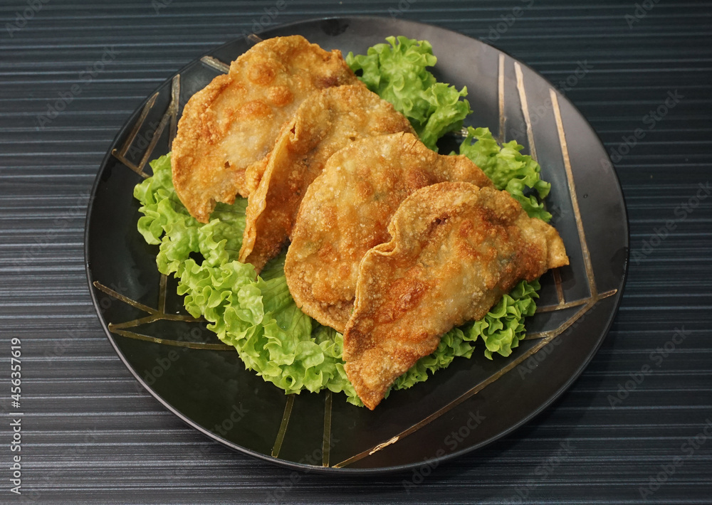 handmade deep fried and boiled pork meat dumpling wanton soup on dark grey wood background dim sum menu handmade deep fried and boiled pork meat dumpling wanton soup on dark grey wood background dim sum menu