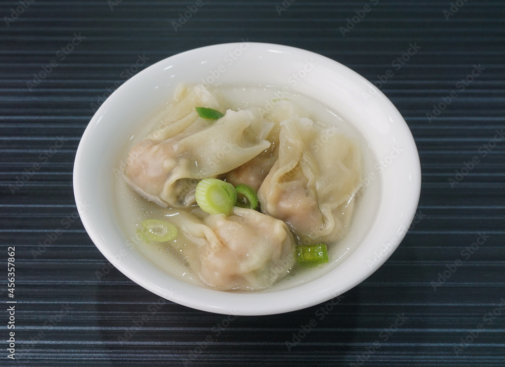 handmade deep fried and boiled pork meat dumpling wanton soup in plate on dark grey wood table asian dim sum halal food restaurant cuisine banquet menu for cafe handmade deep fried and boiled pork meat dumpling wanton soup in plate on dark grey wood table asian dim sum halal food restaurant cuisine banquet menu for cafe