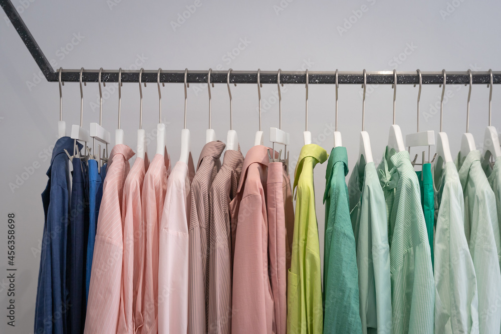 Female casual colorful cotton clothes hanging on the rack wardrobe or closet interior decoration of architecture of modern home contemporary. Female casual colorful cotton clothes hanging on the rack wardrobe or closet interior decoration of architecture of modern home contemporary.