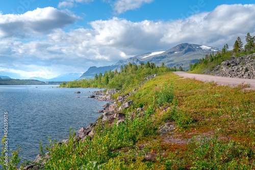 Lulealven lake, Sweden, with mountains of Stora Sjofallet National Park in the back on a day of arctic summer. Wild nature of the far north.