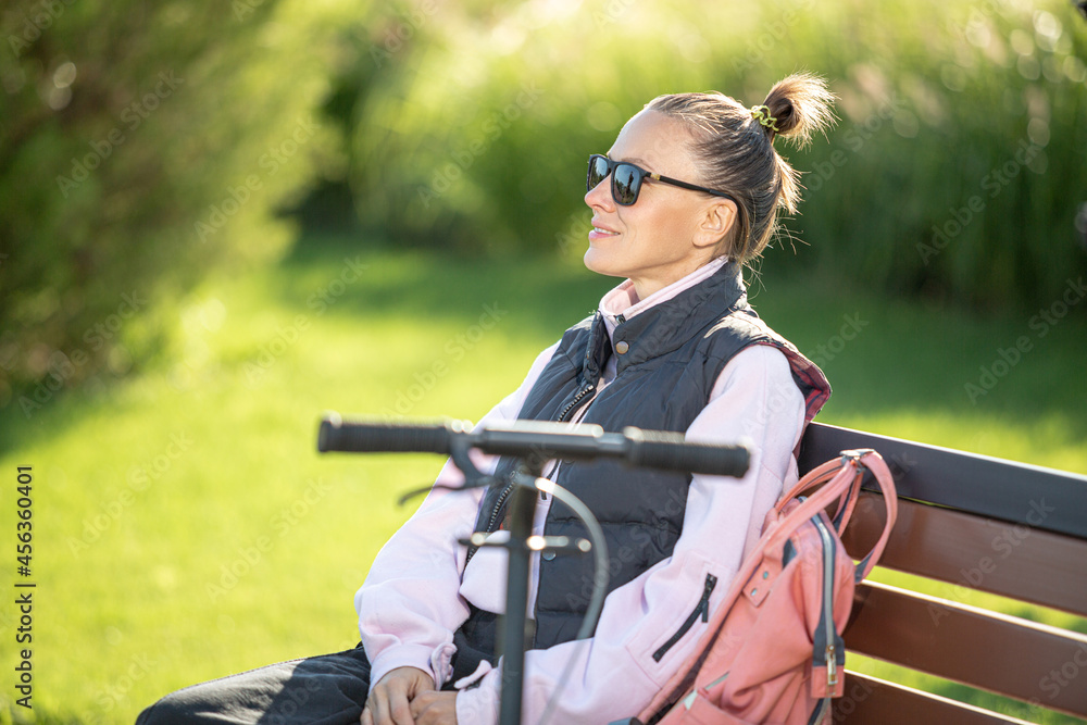 Fototapeta premium Woman relaxing relieving stress on a bench