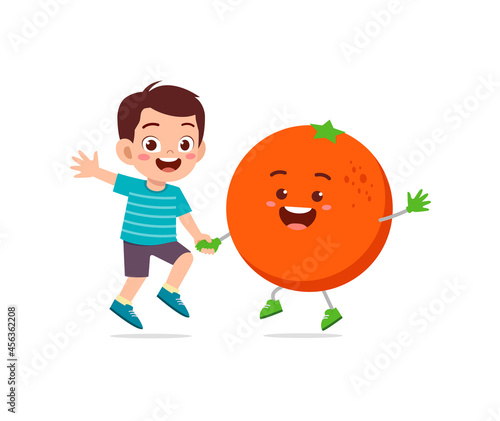 cute little boy stands with orange character © Colorfuel Studio