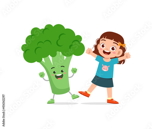 cute little girl stands with broccoli character