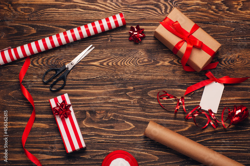 Gift wrapping for christmas and new year. Christmas background with gift boxes, ropes, paper handlebars and decorations on wooden background. Preparing for the holidays. Top view with copy space.