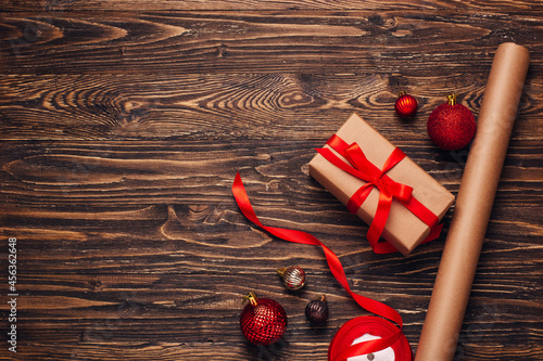 Gift wrapping for christmas and new year. Christmas background with gift boxes, ropes, paper handlebars and decorations on wooden background. Preparing for the holidays. Top view with copy space.