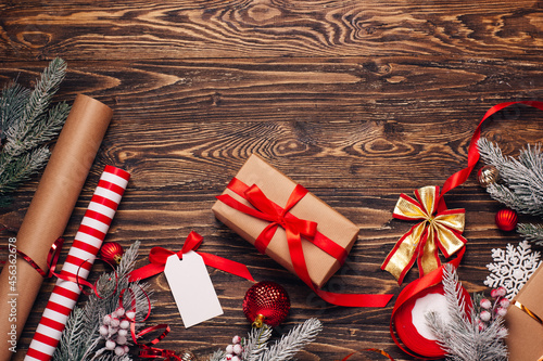 Gift wrapping for christmas and new year. Christmas background with gift boxes, ropes, paper handlebars and decorations on wooden background. Preparing for the holidays. Top view with copy space.