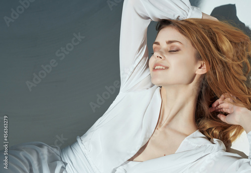 fashionable woman in white dress leans on the wall lifestyle romance