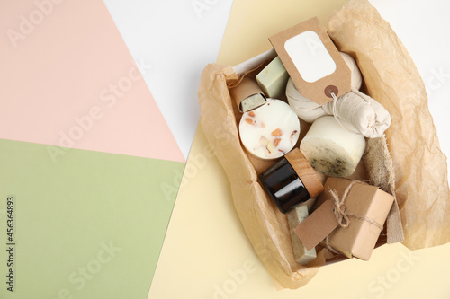 Box with eco friendly personal care products on color background, top view. Space for text photo