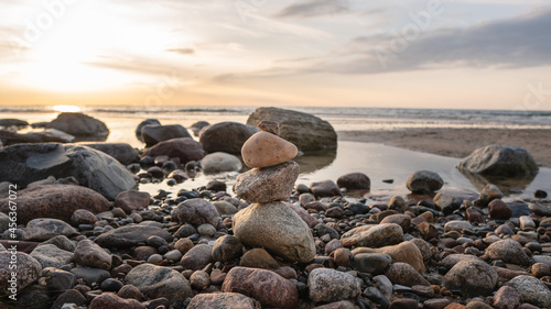 Zen meditation background - balanced stones stack close up on sea beach