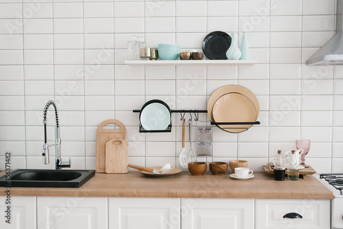 Kitchen utensils and utensils in the bright white wooden kitchen