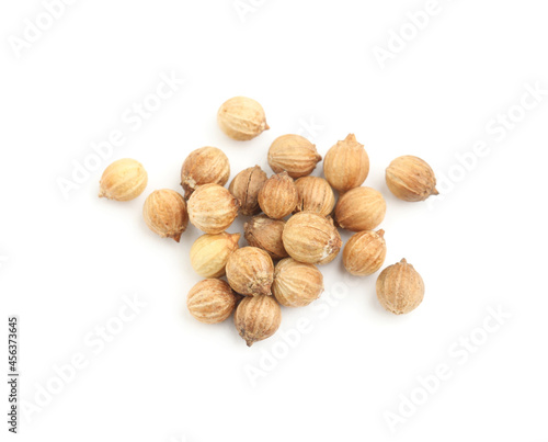 Scattered dried coriander seeds on white background, top view