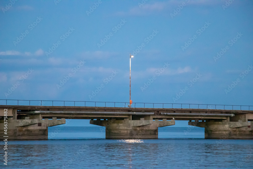 Long nautical pier seascape during a serene summer dusk along a canadian waterfront
